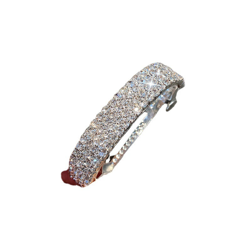 Diamond-encrusted hairpin at the back of the head for a stylish look