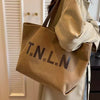 Large-capacity canvas shoulder tote bag.