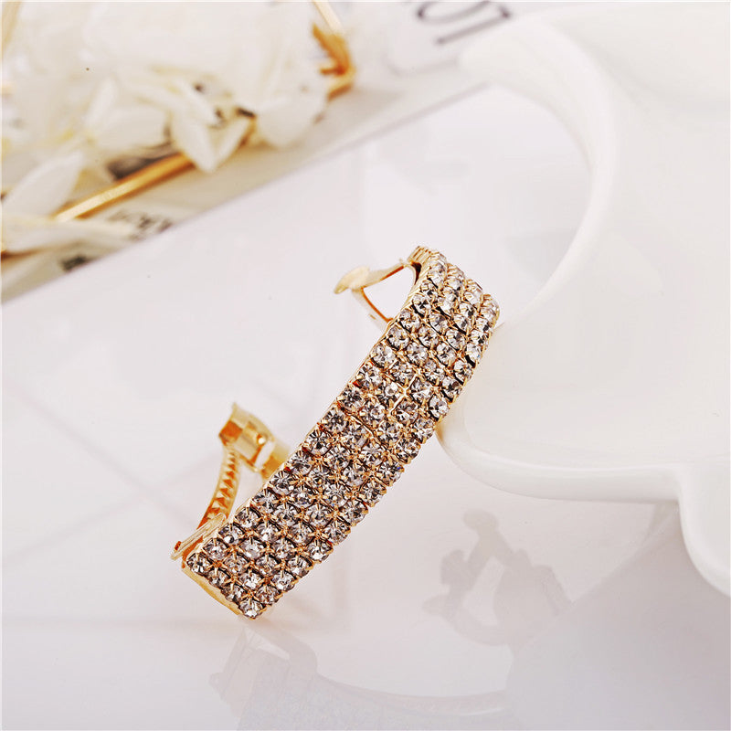 Diamond-encrusted hairpin at the back of the head for a stylish look