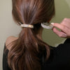 Diamond-encrusted hairpin at the back of the head for a stylish look