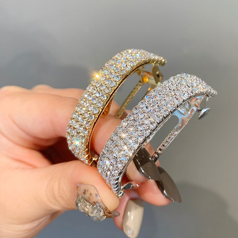 Diamond-encrusted hairpin at the back of the head for a stylish look