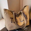 Large-capacity canvas shoulder tote bag.